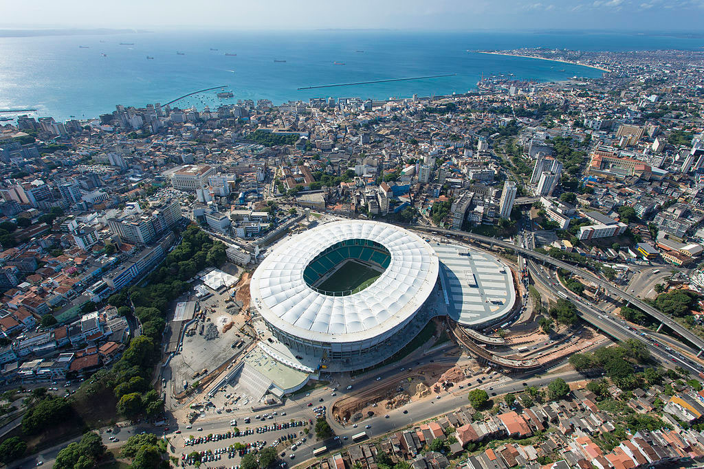 Vista aérea da Arena Fonte Nova Complexo Esportivo Cultural Octávio Mangabeira e seu entorno, em Salvador. Ao fundo, o mar, banhando o litoral.