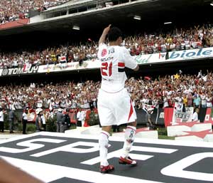 Souza comemorando o título sobre o simbolo do SPFC